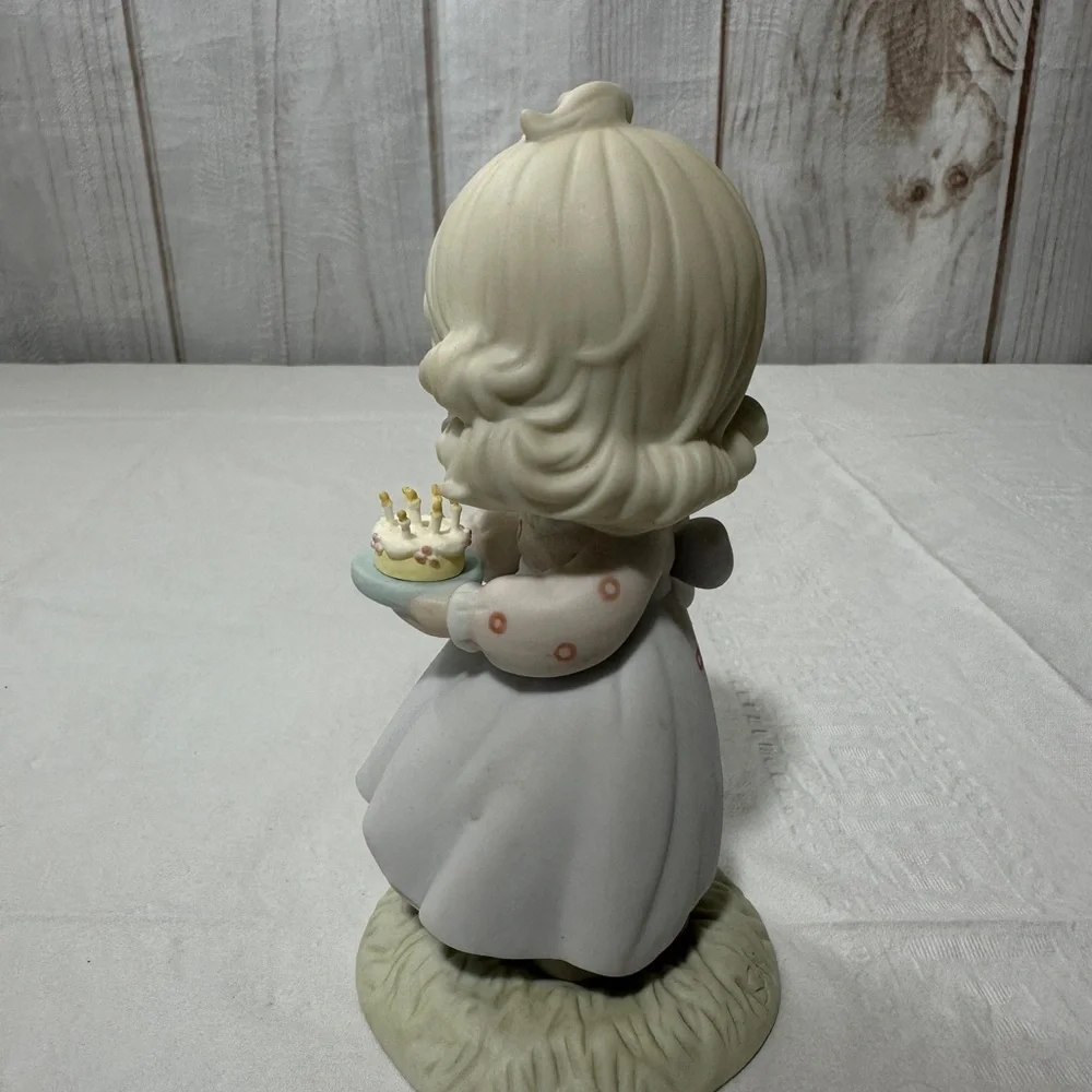 Precious Moment’s figurine titled “May Your Birthday Be A Blessing” from 1990